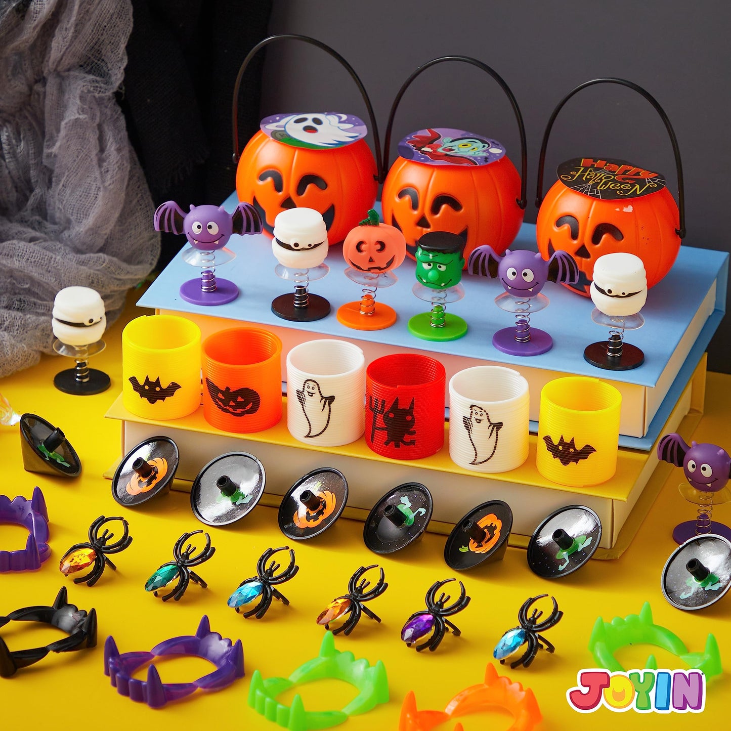 Joyfy 144 Pcs Halloween Toys Party Favors for Kids,Halloween Goodies Including Pumpkin Buckets,Spider Rings,Poppers,Spring,Vampire Teeth and Spinning Tops